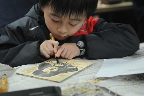 3月3日,一名小朋友在學(xué)刻雷鋒像版畫(huà)。當(dāng)日,“學(xué)刻雷鋒像、學(xué)做雷鋒人”活動(dòng)在中國(guó)美術(shù)學(xué)院舉行?;顒?dòng)由中國(guó)美院版畫(huà)系的老師現(xiàn)場(chǎng)教授50位杭州市民親手制作“雷鋒像”版畫(huà),讓大家在學(xué)習(xí)雷鋒精神的同時(shí)又能親手體驗(yàn)版畫(huà)藝術(shù)。新華社發(fā)(朱引煒 攝)