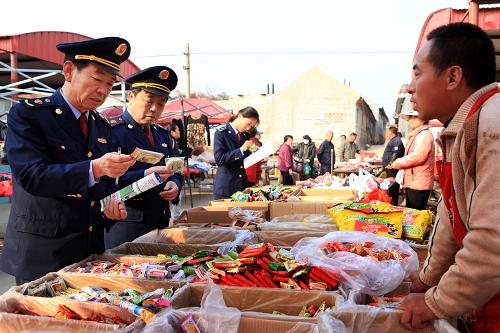 10月31日,在即墨市鰲山衛(wèi)鎮(zhèn)集市上,工商執(zhí)法人員在向攤販詢問食品進貨渠道。近日,山東省即墨市工商部門對轄區(qū)農(nóng)村集市、校園周邊、小賣部銷售的“無廠家、無生產(chǎn)日期、無保質(zhì)期”的“問題食品”進行清查和收繳,并追根溯源搗毀進貨、生產(chǎn)渠道,最大限度確保農(nóng)村食品安全。新華社記者李紫恒攝