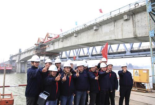 1月22日,施工人員們合影留念,慶祝位于江蘇省揚(yáng)州市的寧(南京)啟(啟東)鐵路復(fù)線京杭運(yùn)河特大橋主跨合龍。新華社發(fā)(張丙濤 攝)
