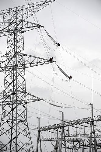 電力工人在寧夏固原市彭堡鎮(zhèn)的變電塔上檢修線路(6月21日攝)。新華社發(fā)(李然 攝)