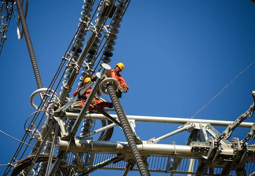 7月3日,浙江省送變電工程公司施工人員在50多米高的輸電線路上進(jìn)行施工。1000千伏浙北變電站位于浙江省安吉縣境內(nèi),是皖電東送特高壓輸電工程浙江境內(nèi)唯一的特高壓站點(diǎn)。1000千伏皖電東送特高壓輸電工程將于九月投產(chǎn),目前施工進(jìn)入最后沖刺階段。1000千伏皖電東送特高壓輸電工程是我國(guó)首條同塔雙回路特高壓交流輸電工程,工程西起安徽淮南,經(jīng)皖南、浙北到達(dá)上海,線路全長(zhǎng)656公里,共有1421座鐵塔,跨越華東27個(gè)地(市)縣。該工程是世界上電壓等級(jí)最高、輸電能力最強(qiáng)、技術(shù)水平最高的輸電工程,工程建成后其每年輸電能力達(dá)500億度,將有效保障浙江、上海的電力供應(yīng)。新華社記者 徐昱 攝