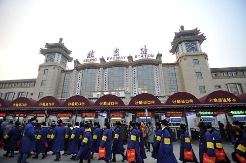 1月8日,負責車票實名制檢查的安檢員從北京火車站站前廣場上走過。當日,為期40天的2012年春運正式啟動。初步預測今年春運期間客流量將達到31.58億人次,同比增長9.1%,其中全國鐵路將發(fā)送旅客2.35億人次,同比增長6.1%。新華社發(fā)(劉長龍 攝)