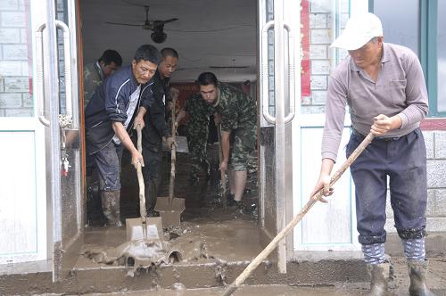 7月3日,在黑龍江省穆棱市下城子鎮(zhèn)新民村,軍民一起清理屋內(nèi)的淤泥和積水。7月2日,黑龍江省穆棱市遭遇暴雨和冰雹天氣,局地短時強(qiáng)降雨超過50毫米,引發(fā)山洪,造成當(dāng)?shù)?個鄉(xiāng)鎮(zhèn)的85個村不同程度受災(zāi)。當(dāng)?shù)卣褑討?yīng)急預(yù)案,及時組織轉(zhuǎn)移災(zāi)區(qū)群眾,積極開展抗災(zāi)自救工作。新華社發(fā)(張春祥 攝)