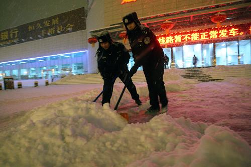 1月2日,山東省煙臺(tái)市汽車總站工作人員在清理站前廣場(chǎng)上的積雪。新華社發(fā)(申吉忠 攝)
