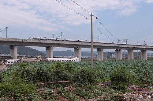 7月25日,一列列車駛過事故路段。當日,甬溫線特別重大鐵路事故路段恢復通車。新華社記者 邢廣利 攝