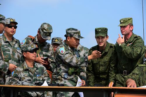 8月6日,在俄羅斯中部軍區(qū)切巴爾庫(kù)爾合同訓(xùn)練場(chǎng),中俄官兵針對(duì)聯(lián)訓(xùn)進(jìn)行研究。“和平使命—2013”中俄聯(lián)合反恐軍事演習(xí)戰(zhàn)役籌劃開始,部隊(duì)訓(xùn)練在切巴爾庫(kù)爾綜合訓(xùn)練場(chǎng)展開。8月6日,雙方參演部隊(duì)進(jìn)行了實(shí)兵實(shí)裝針對(duì)性訓(xùn)練。新華社發(fā)(譚長(zhǎng)俊 攝)