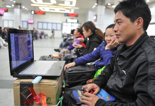 1月12日,等待乘車回湖南永州老家的蔣先生(右一)在候車室用筆記本電腦玩游戲。 近年來,春運旅客隨身攜帶的行李悄然變化,越來越多的人選擇給行李“瘦身”,輕松出行。同時,在候車室里,隨處可見用電子設(shè)備玩游戲、聽歌、上網(wǎng)的旅客。春運期間的這些變化折射出人們生活水平的不斷提高,也反映出社會在物質(zhì)供應(yīng)、物流運輸?shù)确矫嫒找尕S富和完善,地區(qū)間的差異日漸減小。新華社記者 盧漢欣 攝