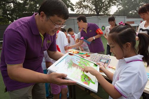 9月10日,北京市匯文第一小學(xué)學(xué)生張疊(右)向校長鄭智學(xué)(左)獻上自己的繪畫作品。在畫中,她把校長想象成長著眼睛的大樹,她自己是在樹下快樂玩耍的學(xué)生。當(dāng)日是我國第28個教師節(jié),學(xué)生們以不同的形式表達對老師的愛。新華社記者 金立旺 攝
