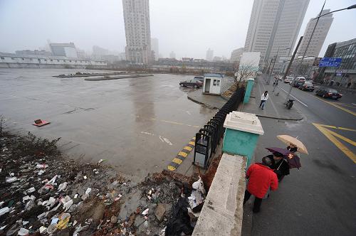 12月28日,幾名路人在上海海門(mén)路55號(hào)地塊外駐足。新華社發(fā)(賴(lài)鑫琳 攝)
