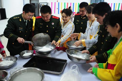 2月22日,朝鮮族群眾與邊防檢查站官兵一同制作元宵。新華社記者 潘昱龍 攝