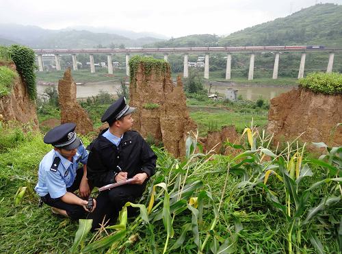 7月16日,鐵路民警在襄渝鐵路四川達(dá)州市一鐵路橋段查勘滑坡區(qū)域災(zāi)情。新華社發(fā)(鄧良奎 攝)