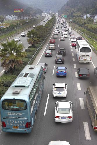 2月15日,排著長(zhǎng)隊(duì)的車輛緩慢有序地進(jìn)入G15沈海高速浙江省溫州市三都嶺隧道。新華社發(fā)(莊穎昶 攝)