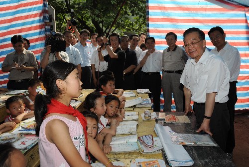 6月20日至22日,中共中央政治局常委、國(guó)務(wù)院總理溫家寶到受汶川大地震波及的陜西、甘肅災(zāi)區(qū)檢查指導(dǎo)抗震救災(zāi)工作,看望干部群眾。這是6月20日,溫家寶在陜西省略陽(yáng)縣權(quán)力村帳篷小學(xué)內(nèi)傾聽(tīng)小學(xué)生宋雪談?wù)鸷蟾惺堋?新華社記者 黃敬文 攝