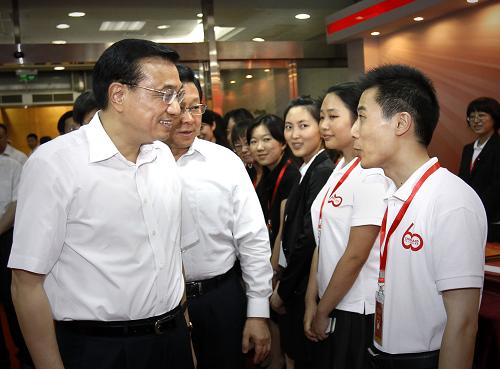 8月12日,中共中央政治局常委、國務(wù)院副總理李克強在北京參觀中國對外援助60周年紀(jì)念展。這是李克強與我國參加對外援助的志愿者交談。新華社記者 劉建生 攝