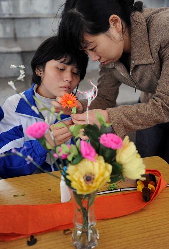 5月16日,長沙縣特殊教育學(xué)校的一位老師在指導(dǎo)學(xué)生制作紙花。 當(dāng)日,湖南省長沙市特殊教育成果展在湘江畔風(fēng)帆廣場舉行。來自長沙地區(qū)幾所特殊教育學(xué)校的學(xué)生通過各種才藝表演,展示他們的自信和美麗。 新華社記者李尕攝
