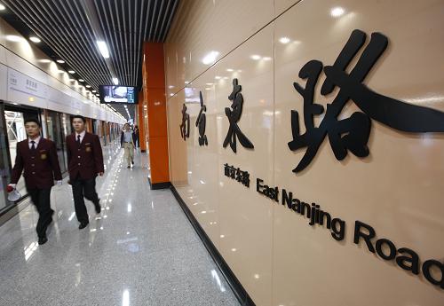 4月10日,兩名工作人員經(jīng)過10號(hào)線南京東路站。 新華社記者 裴鑫 攝