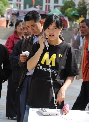 5月14日,甘肅省隴南市文縣城區(qū)一名女子正在使用“親情熱線”。5月12日,與四川省接壤的甘肅省文縣發(fā)生強(qiáng)烈地震后,當(dāng)?shù)仉娦挪块T在城區(qū)設(shè)置了免費(fèi)的親情服務(wù)熱線,讓當(dāng)?shù)鼐用衽c外地的親友保持聯(lián)絡(luò)。