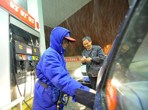 11月9日深夜,一名出租車(chē)司機(jī)趕在11月10日零時(shí)前到北京崇文區(qū)一個(gè)加油站冒雪加油。國(guó)家發(fā)展和改革委員會(huì)9日宣布,自11月10日零時(shí)起將汽、柴油價(jià)格每噸均提高480元,折合零售價(jià)格,90號(hào)汽油和0號(hào)柴油(全國(guó)平均)每升分別提高0.36元和0.41元。