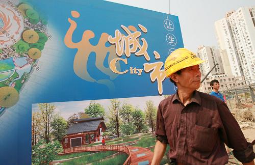 8月27日,一位工人走過“活水公園”工地的效果圖板。新華社記者 任瓏 攝