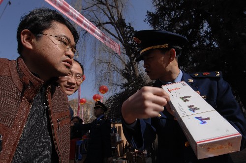 3月12日,工商執(zhí)法人員正在給青海民族大學(xué)師生講解辨別假貨技巧。新華社記者 楊壽德 攝