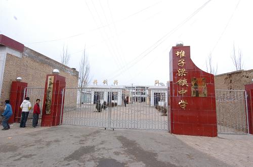 陜西定邊縣堆子梁鎮(zhèn)中學(xué)的校門(12月3日攝)。12月1日夜到2日凌晨,陜西省榆林市定邊縣堆子梁學(xué)校一女生宿舍發(fā)生12名小學(xué)生一氧化碳中毒事件,有11名學(xué)生經(jīng)搶救無效死亡,目前1人仍在搶救當(dāng)中,學(xué)校秩序正常。新華社記者 馮國 攝