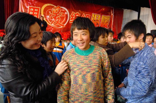 12月10日,“愛(ài)心媽媽”為在山西過(guò)渡復(fù)學(xué)的漩口中學(xué)學(xué)生試穿毛衣。當(dāng)天,山西省婦聯(lián)2008“用愛(ài)編織溫暖——恒愛(ài)行動(dòng)”毛衣發(fā)放儀式在長(zhǎng)治市長(zhǎng)安慈善學(xué)校舉行,“愛(ài)心媽媽”們?yōu)樵诖诉^(guò)渡復(fù)學(xué)的四川映秀漩口中學(xué)的1千多名學(xué)生送去過(guò)冬的新毛衣。新華社發(fā)(梁棟 攝)