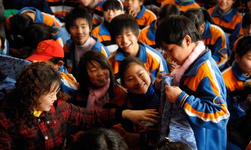 12月10日,在山西過(guò)渡復(fù)學(xué)的漩口中學(xué)學(xué)生收到“愛(ài)心媽媽”送來(lái)的毛衣。新華社發(fā)(梁棟 攝)