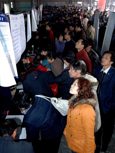 2月7日,在西安市丈八路人力資源市場“春風行動專場招聘會”現場,求職者在查看招聘信息。新華社記者 丁海濤 攝