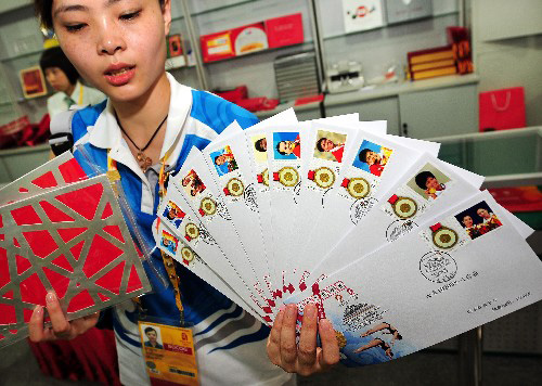 8月19日,一位志愿者在展示“第29屆奧運(yùn)會(huì)中國體育代表團(tuán)奪金紀(jì)念”郵品。 當(dāng)日,“第29屆奧運(yùn)會(huì)中國體育代表團(tuán)奪金紀(jì)念”郵品在北京奧運(yùn)村的中國郵政代辦點(diǎn)開始發(fā)售。郵品中的紀(jì)念封正面印有運(yùn)動(dòng)員比賽精彩瞬間和賽場(chǎng)圖片,加蓋奧運(yùn)場(chǎng)館郵戳,并貼有奪金運(yùn)動(dòng)員個(gè)性化郵票。 新華社記者李紫恒攝