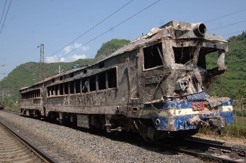 寶成線109隧道損壞機車頭已拉出 5月16日,事故機車頭停放在虞關車站。寶成線109隧道搶險救援工作取得重大進展,隧道口嚴重損毀火車的第一節(jié)機車已經(jīng)于當日上午7時30分復軌被拉出隧道,并停放在附近的虞關車站,其余39節(jié)車輛還在隧道內。寶成鐵路是我國西北通向西南的大動脈,擔負著向四川災區(qū)運送人員和物資的重要任務。109隧道受阻,對四川抗震救災工作造成嚴重影響。 新華社記者丁海濤攝