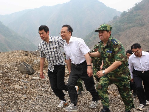 6月6日,中共中央政治局常委、國務(wù)院總理、國務(wù)院抗震救災(zāi)總指揮部總指揮溫家寶繼續(xù)在綿陽考察唐家山堰塞湖除險工作,看望部分轉(zhuǎn)移安置群眾和參加唐家山堰塞湖搶險工作的武警水電部隊官兵、水利專家,要求按照安全、科學(xué)、快速的原則,采取果斷措施,盡快解除唐家山堰塞湖的威脅。這是溫家寶再次實地察看堰塞湖后,頂著螺旋槳產(chǎn)生的巨大氣流艱難地靠近直升機,準(zhǔn)備返回綿陽。 新華社記者劉衛(wèi)兵攝