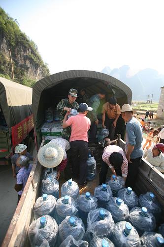 深圳邊防官兵馳援百色抗旱 4月5日,武警深圳邊防七支隊(duì)官兵將飲用水送到靖西縣安德鎮(zhèn)三錄村群眾手中。 當(dāng)日,武警深圳邊防七支隊(duì)將深圳軍民捐贈(zèng)的45噸飲用水和7600公斤大米運(yùn)抵廣西百色市靖西縣安德鎮(zhèn)三錄村個(gè)節(jié)屯,幫助旱區(qū)群眾渡過(guò)難關(guān)。 新華社發(fā)(陳培高 攝)
