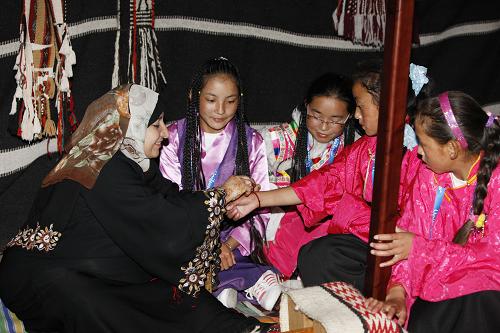 玉樹災(zāi)區(qū)學(xué)生走進(jìn)世博園 9月15日,在上海世博園卡塔爾館內(nèi),一位卡塔爾女士將駱駝毛編織而成的吉祥手環(huán)系在來自青海玉樹地震災(zāi)區(qū)的女孩手上。 當(dāng)日,青海玉樹地震災(zāi)區(qū)兩所希望學(xué)校的30名中小學(xué)生受聯(lián)合利華公司資助來到上海參觀世博園。第一次離開家鄉(xiāng)的他們?cè)谥驹刚吲惆橄?,走進(jìn)英國(guó)、中國(guó)、芬蘭、丹麥、盧森堡等國(guó)家館,零距離感受世博魅力。 新華社記者任正來攝