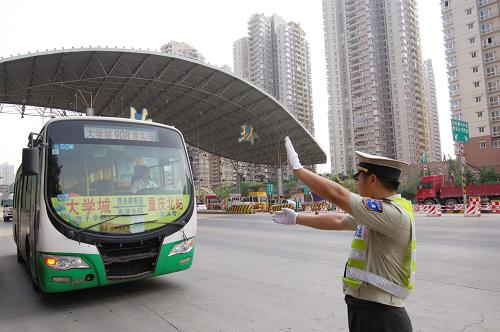 7月16日,重慶高速公路執(zhí)法支隊四大隊的一名執(zhí)法人員正在高速公路入口引導一輛客車靠邊停車接受檢查。日前,為確保高溫天氣重慶高速公路的運輸安全,重慶高速公路執(zhí)法支隊在增強執(zhí)法力度的同時,推行人性化執(zhí)法。通過在各大高速公路入口設立的安全檢查服務站,向客運車輛駕駛員發(fā)放夏季安全行駛知識讀本,免費提供瓶裝水和防暑降溫藥品,保障高溫天氣下的客運安全。新華社記者 劉潺 攝