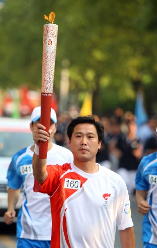 5月17日,畬族火炬手、小學(xué)教師雷旭雄在進(jìn)行傳遞。當(dāng)日,北京奧運(yùn)會(huì)圣火在浙江紹興傳遞。 新華社記者邢廣利攝