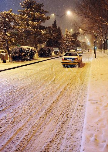 3月14日,車輛在雪中的長春街頭行駛。當(dāng)日,吉林省出現(xiàn)大范圍降雪天氣。吉林省氣象臺(tái)發(fā)布暴雪黃色預(yù)警信號,預(yù)計(jì)15日長春市還將迎來暴雪天氣。新華社記者 王昊飛 攝