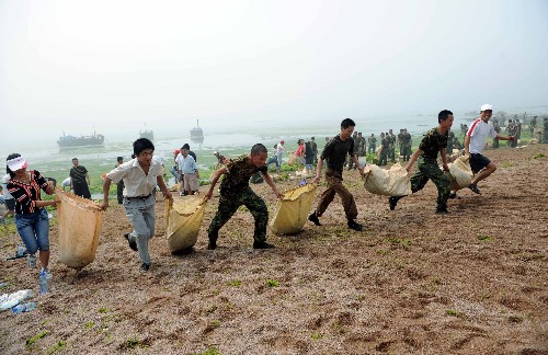 7月3日,軍民攜手在太平灣運(yùn)滸苔。 新華社記者 范長國 攝