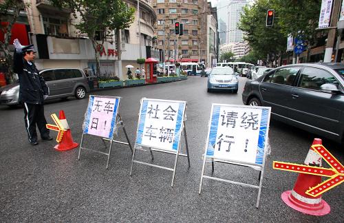 9月22日,一名上海交警正在限行路段指揮社會(huì)車輛繞行。為配合無車日活動(dòng),上海特地劃定南京西路石門二路至華山路段作為無汽車示范區(qū),從22日8時(shí)至22時(shí)半除公交車、出租車及特種車輛外,其它機(jī)動(dòng)車一律不準(zhǔn)駛?cè)搿.?dāng)日是第三個(gè)“中國城市無車日”,今年“無車日”的主題是“健康環(huán)保的步行和自行車交通”,全國各地開展了自行車巡游、主題展板宣傳、市民簽名等多種形式的活動(dòng)宣傳綠色出行。新華社記者 裴鑫 攝
