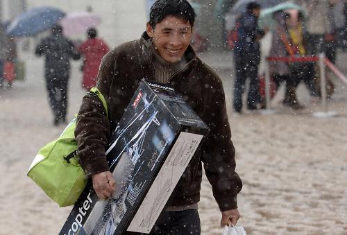 3月6日,一名剛下火車的旅客在風(fēng)雪中前行。新華社記者 李健 攝