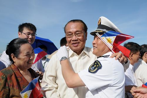 4月17日,在菲律賓馬尼拉南港,中國(guó)人民解放軍海軍525護(hù)航編隊(duì)指揮員邱延鵬大校(右一)與菲律賓華人代表話別。新華社記者 譚衛(wèi)兵 攝