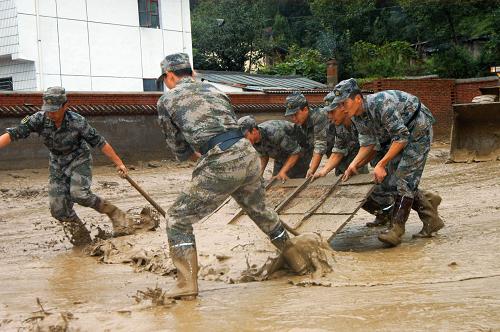 第二炮兵某部官兵在重災(zāi)區(qū)黃渚鎮(zhèn)小太陽(yáng)幼兒園清理淤泥(8月20日攝)。新華社記者 吳明軒 攝