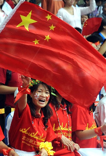 9月17日,身穿紅色T恤的女觀眾在國(guó)家體育場(chǎng)“鳥巢”為運(yùn)動(dòng)員吶喊助威。