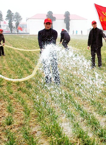 2月4日,南陽市臥龍區(qū)青年志愿者抗旱服務小分隊幫助農(nóng)戶抗旱澆麥。新華社發(fā)(熊運彬 攝)