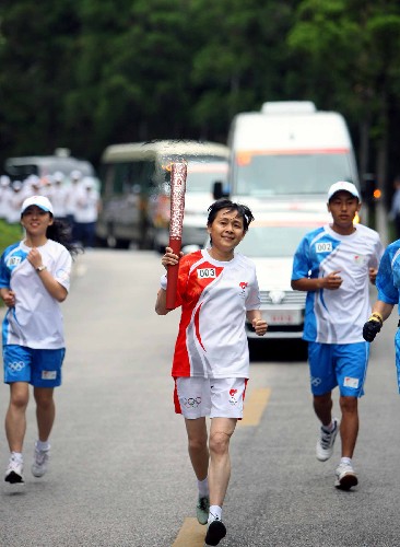 5月15日,奧運火炬手廖曉義手持火炬?zhèn)鬟f。當日,北京奧運圣火傳遞活動在江西井岡山舉行。 新華社記者 邢廣利 攝