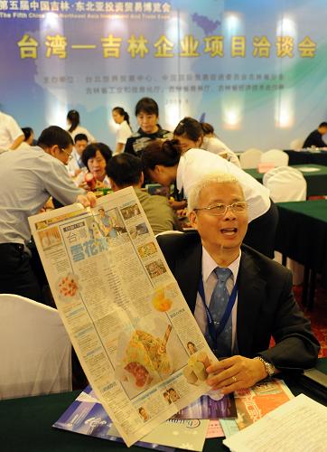 9月1日,“臺(tái)灣——吉林企業(yè)項(xiàng)目洽談會(huì)”上,臺(tái)灣翔美食品興業(yè)股份有限公司總經(jīng)理方榮楠手舉報(bào)道自己公司的報(bào)紙向大陸客商介紹“雪冰花”冷飲。新華社記者 蔣林 攝
