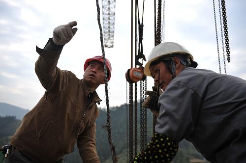 在貴廣高速公路建設(shè)現(xiàn)場(chǎng),工人們正在緊張施工(2009年12月20日攝)。新華社記者 歐東衢攝
