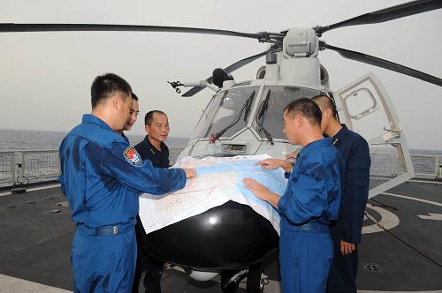 6月21日,正在亞丁灣、索馬里海域執(zhí)行護(hù)航任務(wù)的中國海軍第五批護(hù)航編隊“廣州”艦上,官兵為即將執(zhí)行夜間著艦訓(xùn)練的直升機設(shè)計飛行路線。新華社記者劉春暉攝