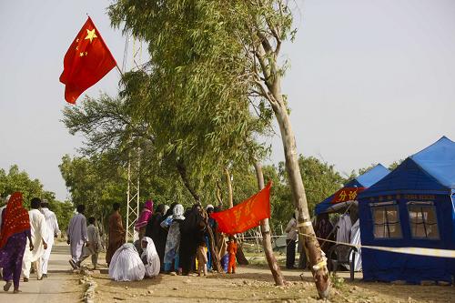 9月18日,在巴基斯坦南部受洪災最嚴重的特達地區(qū)馬克里鎮(zhèn),巴基斯坦民眾在中國國際救援隊流動醫(yī)院排隊就診。新華社記者周磊攝