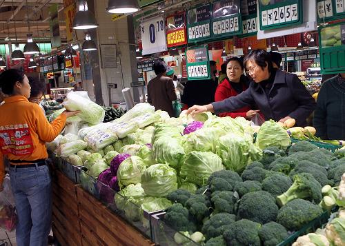 11月23日,消費者在上海市普陀區(qū)一室內(nèi)菜場選購蔬菜。 為加大農(nóng)副產(chǎn)品供應(yīng),降低流通成本,近期上海市普陀、楊浦、閘北、虹口四個區(qū)開始試點蔬菜“直供直銷”模式,郊區(qū)的蔬菜專業(yè)合作社與標(biāo)準(zhǔn)化菜市場簽訂合同,實現(xiàn)從田頭到市場,無中間環(huán)節(jié)的直接銷售,讓市民買到便宜菜。 新華社記者 陳飛 攝