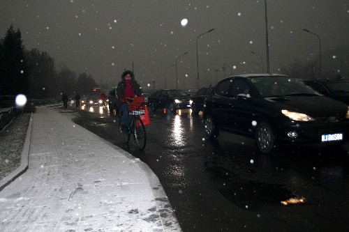 12月10日清晨,車(chē)輛在雪中行進(jìn)。 新華社記者 譚亞凌 攝